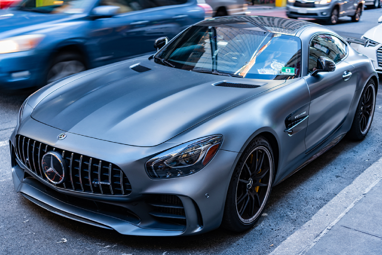 Dark grey Mercedes parked in a parking lot.